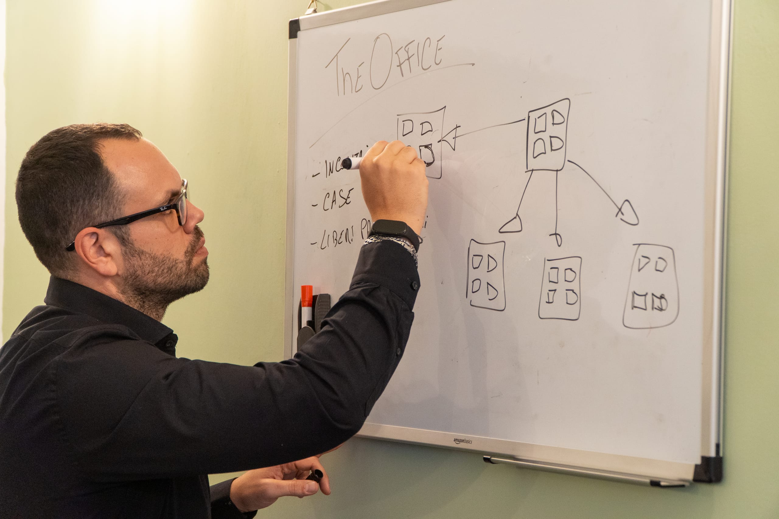 Armando Ferrandino disegna alla lavagna lo schema delle pagine di un portale turistico